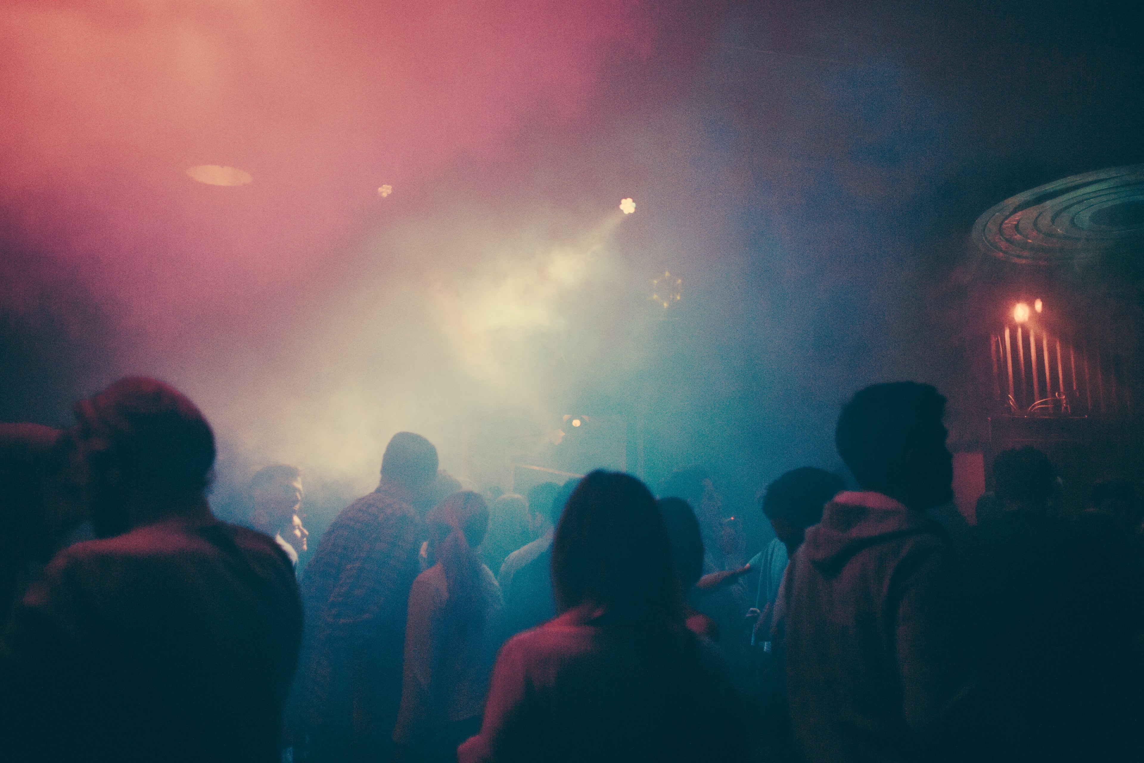 crowd enjoying concert with light show & fog effects